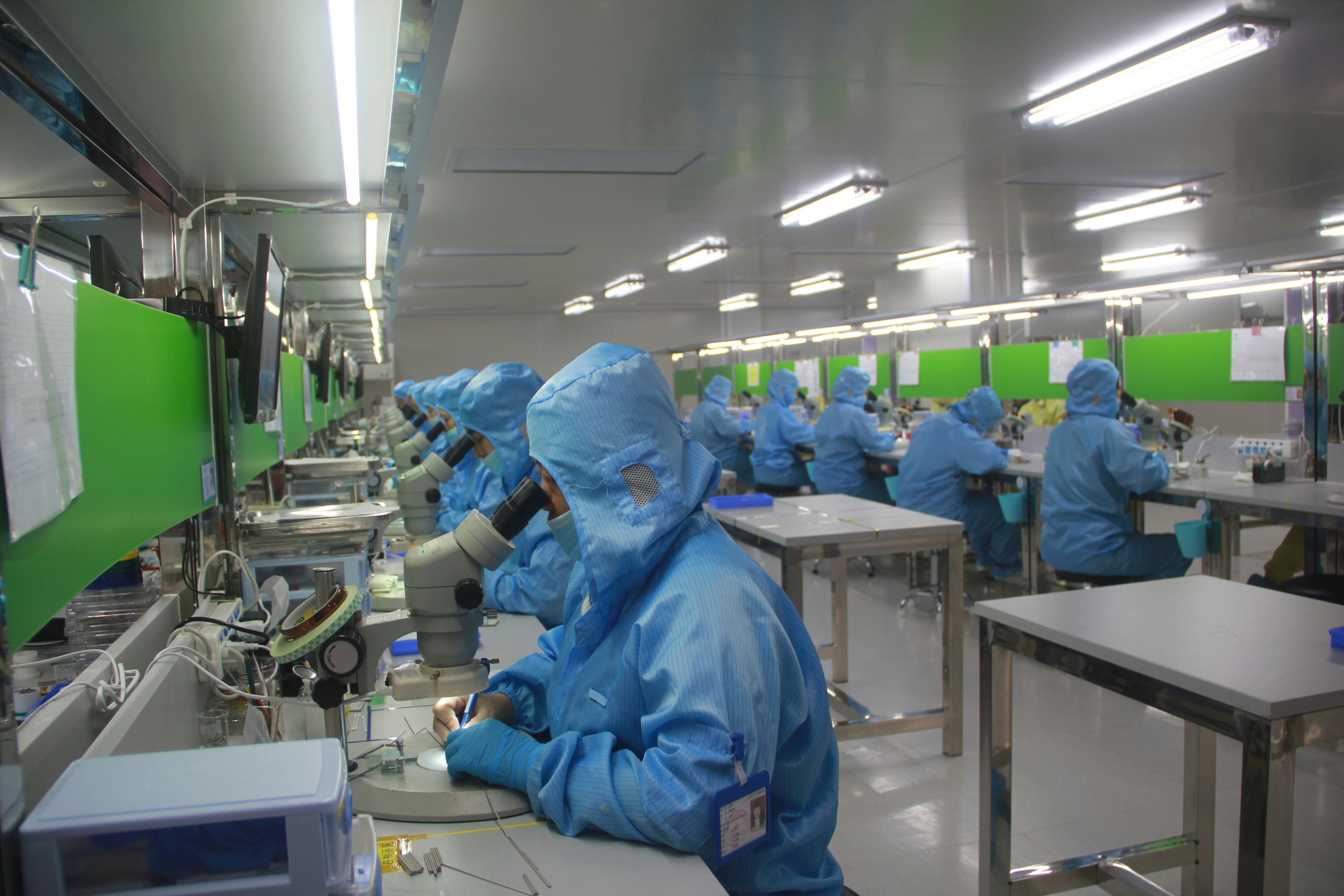 Workers assembling components on a solar manufacturing line.